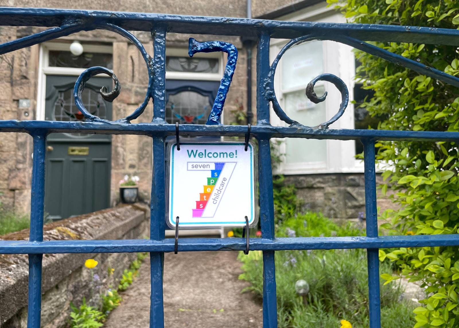 Seven Steps Childcare front gate with sign